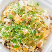 Nachos Supreme · With choice  of meat, pinto beans, cheese sauce, pico de gallo, jalapeños, lettuce, and sour...