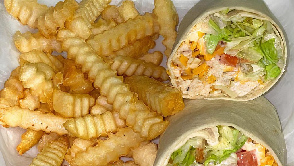 Buffalo Ranch Chicken Wrap · Fried chicken tender  with ranch and buffalo sauce topped with lettuce, cheese, and pic de gallo.