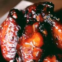Smoked Chicken Wings · 10 of our smoked and dry rubbed wings covered in our signature glaze. Mixed drumettes and fl...