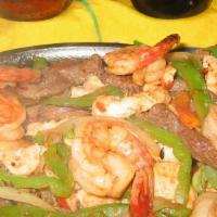 Fajitas De Camaron · Grilled shrimp with sautéed peppers and onions, served with sour cream and guacamole.
