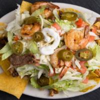 Fajita Nachos Mixtas · Bed of tortilla chips with beans your choice of two meat with cooked tomatoes onion and gree...