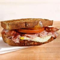 Breakfast Club · Ham & bacon with melted cheddar cheese, fresh cracked egg, and tomato on toasted multigrain ...
