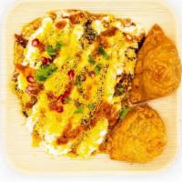 Samosa Chat · Savory snack made with chick peas, samosas and assorted sauces