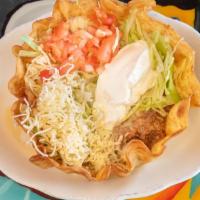 Taco Salad · A crisp, flour tortilla filled with ground beef or chicken and fried beans, lettuce, tomatoe...