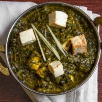 Saag Paneer · Spinach sautéed with homemade cheese, onions, tomatoes and touch cream.