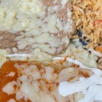 Lunch Enchiladas Suizas · Two chicken enchiladas topped with a creamy tomatillo sauce, queso fresco and sour cream. Se...