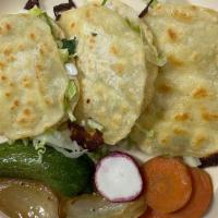 Mulitas · two corn tortillas with mozarella cheese, meat, onions, cilantro and lettuce