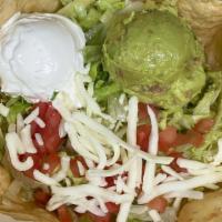 Taco Salad · beans, meat of your choice, guacamole, sour cream, tomatoes, cheese, and  lettuce all in a f...