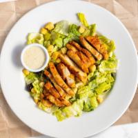 Classic Chicken Caesar Salad · Crisp romaine lettuce, parmesan cheese and crunchy croutons. Served with caesar dressing on ...