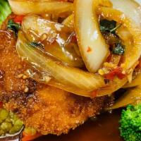 Thai Chili Tilapia · Crispy tilapia filet served over a bed of steamed mixed vegetables with Thai style chili sau...