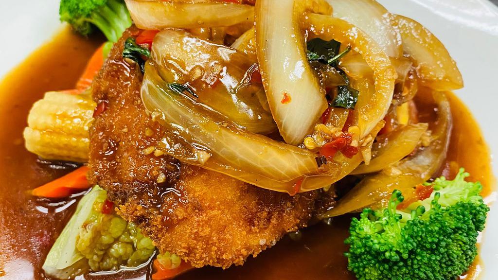 Thai Chili Tilapia · Crispy tilapia filet served over a bed of steamed mixed vegetables with Thai style chili sauce on top. Served with white jasmine rice. Cooked medium spicy.