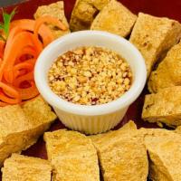Golden Fried Tofu · Crispy fried tofu served with sweet and sour dipping sauce and crushed peanuts.