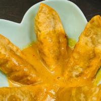 Thai Potstickers  · Fried dumplings served with curry sauce.