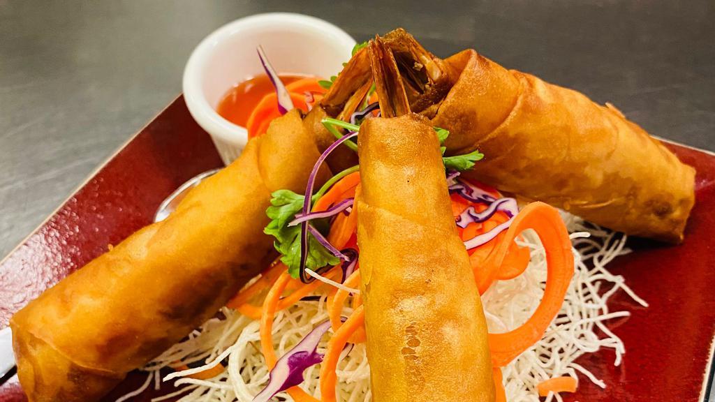 Shrimp Bikini · Crispy tiger shrimp wrapper in spring roll wrapper and stuffed with celery, carrot, and cabbage. Served with sweet and sour sauce. Three pieces.