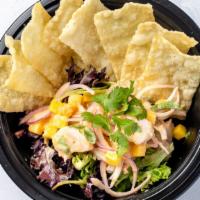 Tahitian Style Shrimp Poke · Cooked Shrimp, Mango, Red Onion, Cilantro. Mixed with Coconut Sauce. Served with Wonton Chip