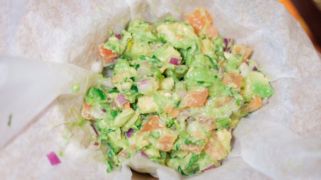 Table Side Mexican Guacamole · Fresh guacamole prepared with fresh lime juice, red onions, cilantro, tomatoes, jalapeños, and avocados.