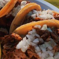 Bbq Tacos · Three pulled pork Bbq tacos topped with our famous Bbq sauce,cheese and shredded cabbage.