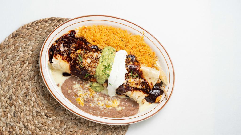 Burrito California · Flour tortilla filled with grilled chicken, grilled onions, and cheese, and then topped with our family recipe mole and cheese dip. Side of guacamole and sour cream. Served with rice and beans.