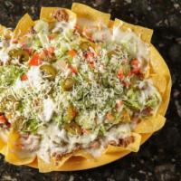 Nachos Supreme · Ground beef or shredded CK topped with lettuce, pico de gallo and sour cream.