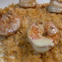 Shrimp Fried Rice · Grilled shrimp over a bed of rice and cheese sauce.