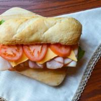 Club Sub · 9 inch italian sub roll with sliced ham, turkey, melted provolone and mozzarella, topped wit...