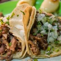 Taco · A traditional Mexican dish consisting of a small hand-sized corn or flour tortilla topped wi...