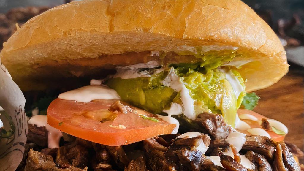 Torta · Imagine that a sandwich and a taco got married and had a kid. That kid would be named Torta. Telera Bun, Choice of meat, cheese, onions, cilantro, tomato, guacamole, refried beans, and crema.