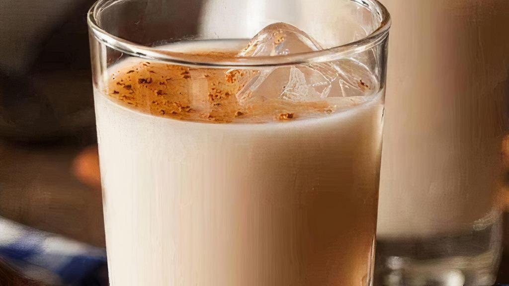 Horchata · Horchata, or orxata (Valencian: [oɾˈʃata]), is a name given to various flavoured plant milk beverages of similar taste and appearance. It originated at least as far back as 13th-century Valencia, where it is known as chufa horchata. In Spain it is made with soaked, ground, and sweetened tiger nuts, but in Mexico and other parts of the Americas the base is white rice
