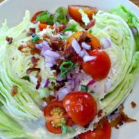 Iceberg Wedge · Tomatoes, onions, bacon, blue cheese crumbles, blue cheese dressing