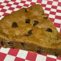 Slice Of Chocolate Chip Cookie Cake  · A generous slice of our delicious and creamy chocolate chip cookie cake.  This cake is chock...