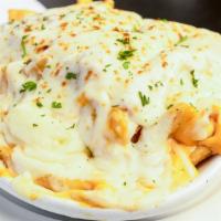 Zeus'S Fries · Godly steak cut fries topped with liquid gold, sauteed onions, mozzarella, cajun ranch and o...