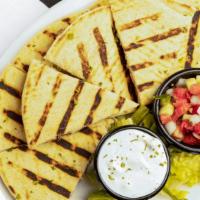 Pitadilla · Our mediterranean version of a quesadilla! just pick your protein and we will bake it with m...