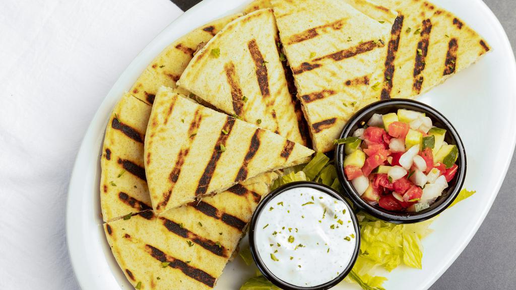 Pitadilla · Our mediterranean version of a quesadilla! just pick your protein and we will bake it with mozzarella cheese, a side of our fresh crisp aladdin salsa served with your choice of dipping sauce. Try cajun ranch or tzatziki.