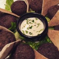 Falafel Appetizer · Vegan, Vegetarian. Ground chickpeas with minced parsley, onions and spices and fried in vege...