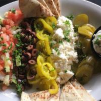 Kabees Plate · Vegetarian. Black kalamata olives, feta cheese, pickled peppers and cucumbers, served with h...