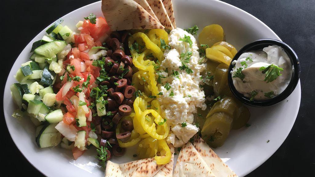 Kabees Plate · Vegetarian. Black kalamata olives, feta cheese, pickled peppers and cucumbers, served with hot pita.
