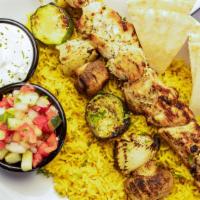 Chicken Kabob · Served on a bed basmati rice, a skewer of vegetables, choice of one side and dipping sauce.