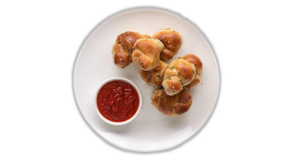 6 Garlic Knots · Freshly baked with savory blend of fresh garlic, virgin olive oil, oregano & parsley. Finished with parmesan.