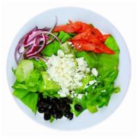 Side Greek Salad · Crumbled feta, black olives, tomatoes, red onions, green peppers tossed over crisp lettuce.