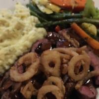 Black Angus Tenderloin Filet Mignon · 8-0 oz, black Angus, premium dry-aged, topped with herb butter and crisp onion rings.