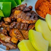 Suya Plate · (Grilled beef) Served with fresh cut onions, Spicy sauce.