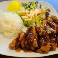 Pork Tonkatsu · Fried pork cutlets with white rice and side salad Served with katsu sauce and house dressing...