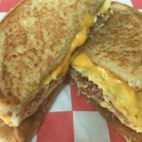 Bacon Egg & Cheese Sandwich · Crumbled bacon in a folded egg topped with American cheese in a large buttered and grilled t...