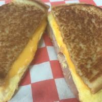 Ham Egg & Cheese Sandwich · Sliced ham on a folded egg topped with American cheese in a large buttered and grilled toast...
