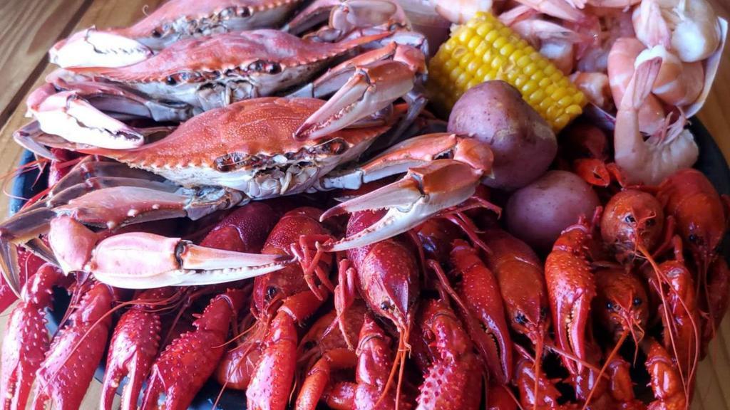 Crawdaddy Platter · *Fan Favorite* Why choose when you can have it all!  2 lbs boiled crawfish, three medium blue crabs, 1/2 lb shrimp + a corn & 2 potatoes.