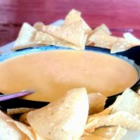Queso · House made yellow cheese dip with tortilla chips.