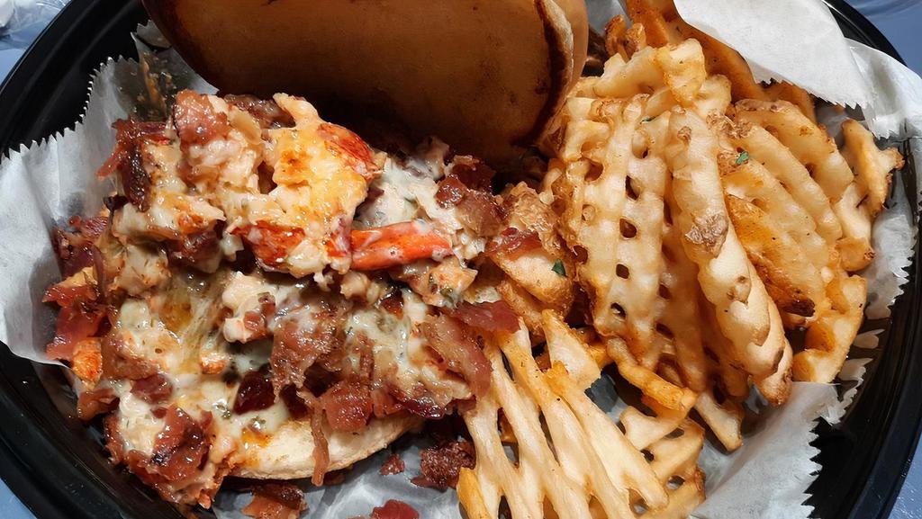 Surf & Turf Burger · Juicy 8 0z burger, marinated lobster, crispy bacon, cilantro creme, mixed chzzz, on brioche bun