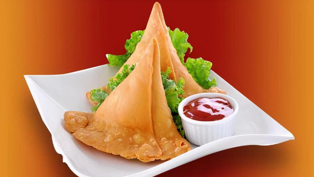 Vegetable Samosa · Traditional stuffed triangle pastries with spiced potatoes and peas.