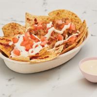 Nachos · Your choice of slow cooked meats over a large serve of chips topped with pinto or black bean...