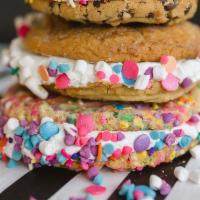Swoozie Doozie · Two of our giant chocolate chips sandwiched around yummy buttercream and rolled in sprinkles.